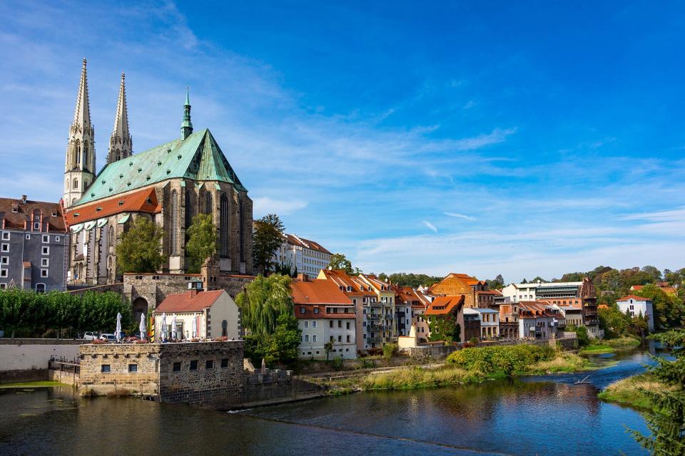 River Amidst Buildings In City Against Sky in Görlitz, Germany