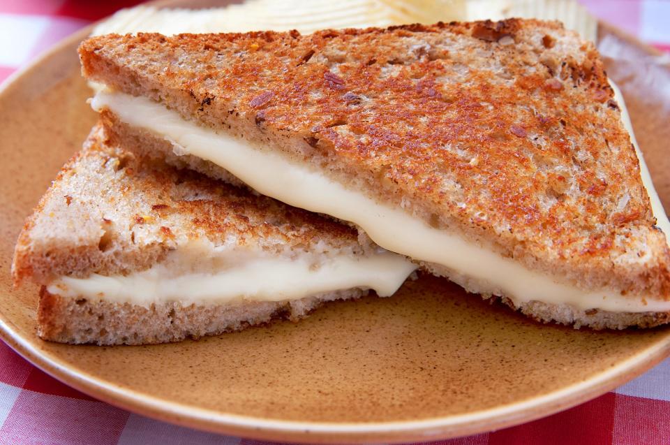 grilled cheese sandwich cut diagonally on a plate