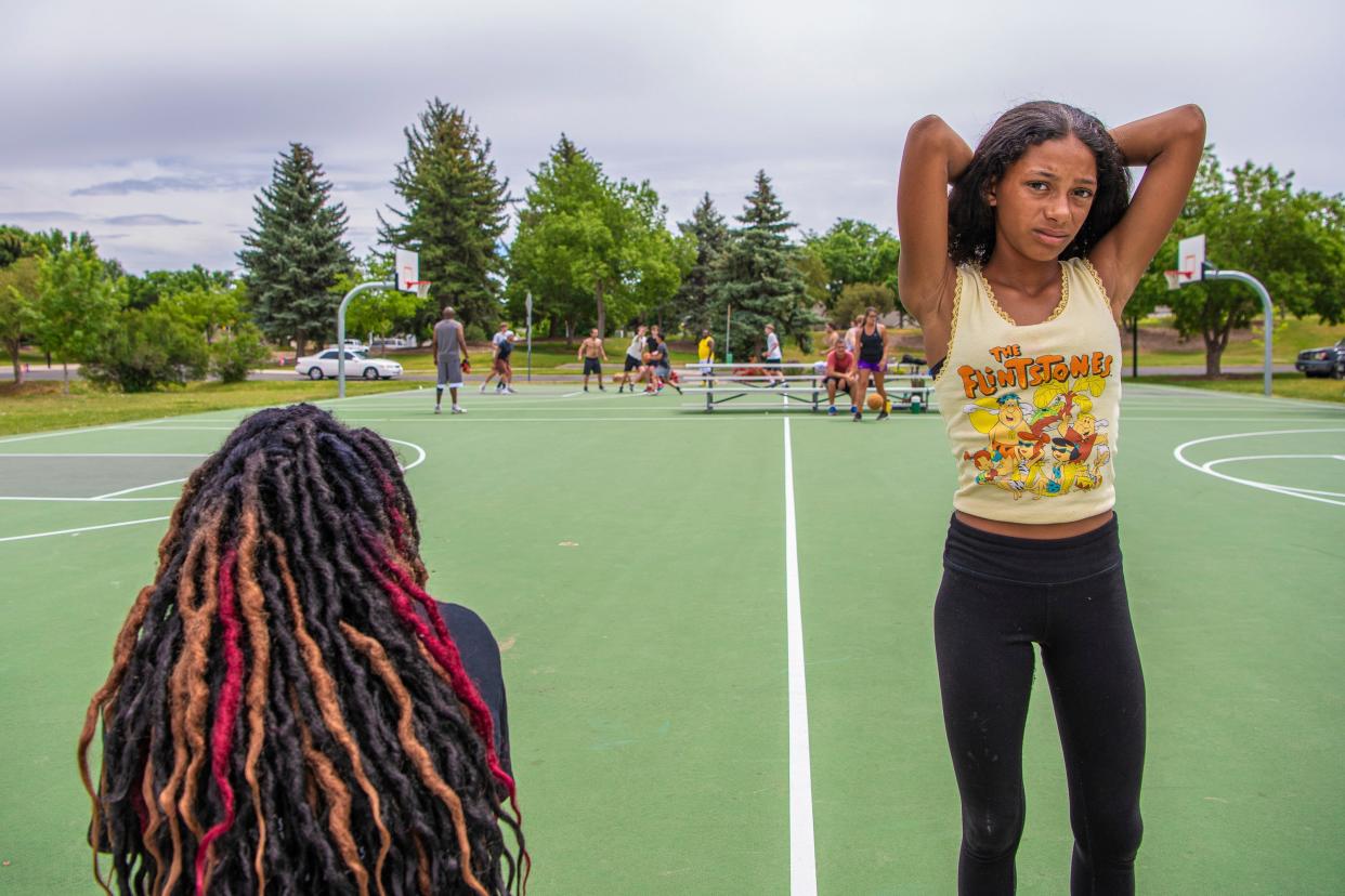 Olivia Curran, left, watches a 3-on-3 tournament held at Rolland Moore Park during Juneteenth celebrations in Fort Collins in 2022. A sales tax will fund infrastructure improvements at parks like Rolland Moore.