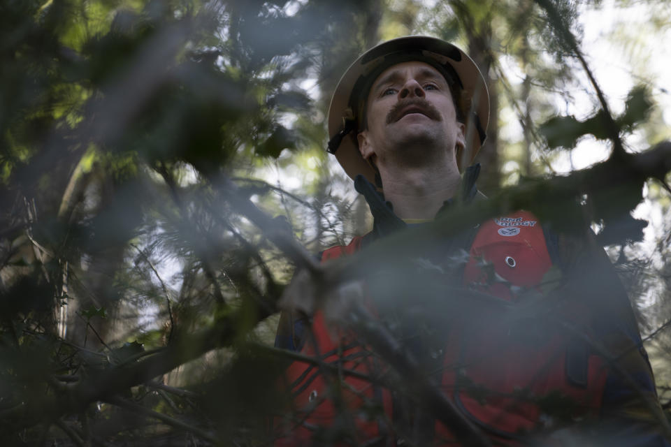 Washington State Department of Natural Resources geologist Mitch Allen examines the site of a landslide in the Capitol Forest, Thursday, March 14, 2024, in Olympia, Wash. (AP Photo/Jenny Kane)