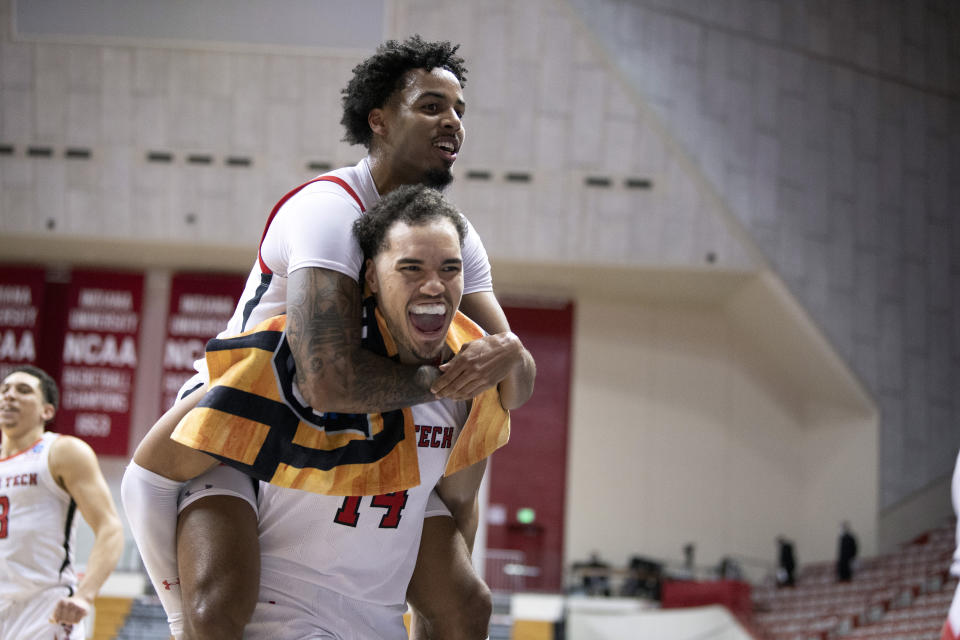Texas Tech's Kyler Edwards, top, and Marcus Santos-Silva (14) celebrate after a first-round game against Utah State in the NCAA men's college basketball tournament, Friday, March 19, 2021, at Assembly Hall in Bloomington, Ind. (Ben Solomon/Pool Photo via AP)