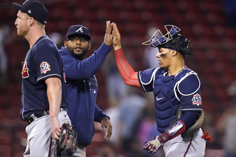 Atlanta Braves' Pablo Sandoval, center, congratulates catcher William Contreras, right, after defeating the Boston Red Sox in a baseball game at Fenway Park, Tuesday, May 25, 2021, in Boston. Sandoval had three singles in the 3-1 win. At left is Atlanta Braves relief pitcher Will Smith. (AP Photo/Charles Krupa)
