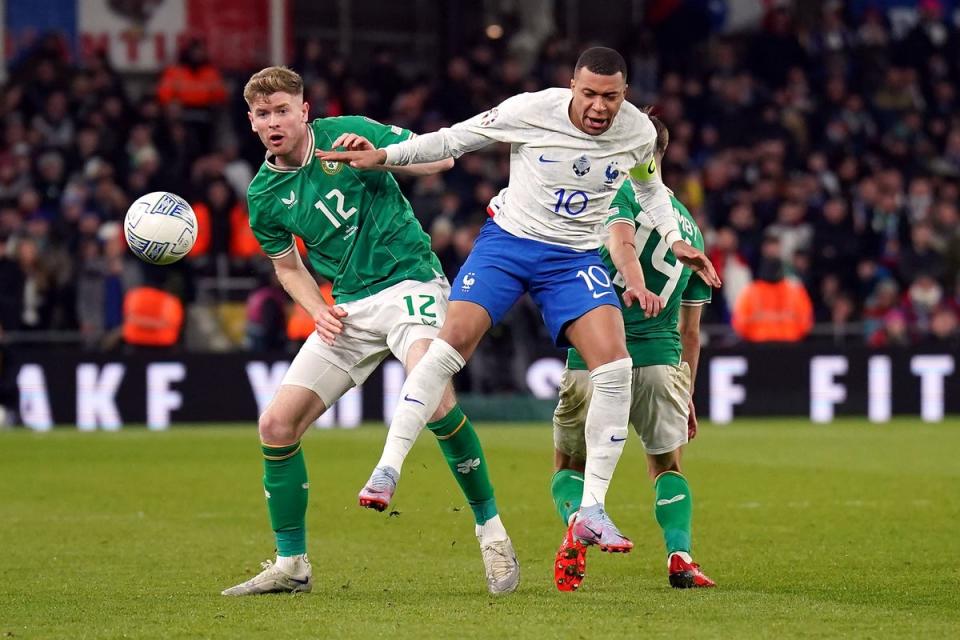 Republic of Ireland’s Nathan Collins, left, and France’s Kylian Mbappe (Niall Carson/PA) (PA Wire)