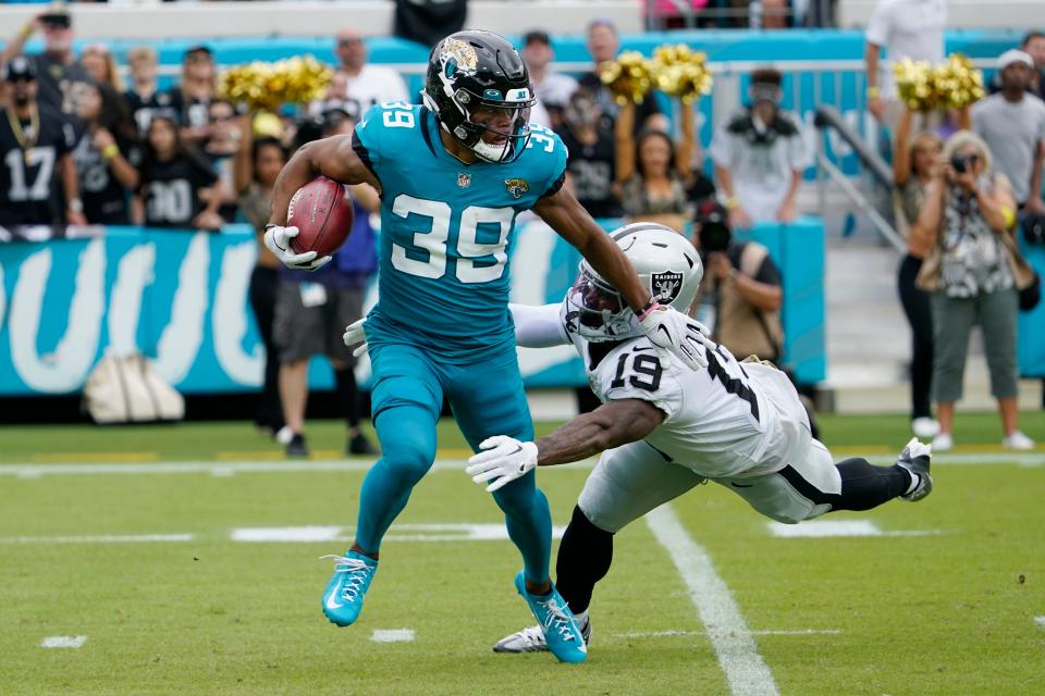 Jacksonville Jaguars' Jamal Agnew (39) is stopped by Las Vegas Raiders' DJ Turner (19) as Agnew returns a kickoff in the first half of an NFL football game Sunday, Nov. 6, 2022, in Jacksonville, Fla. (AP Photo/John Raoux)