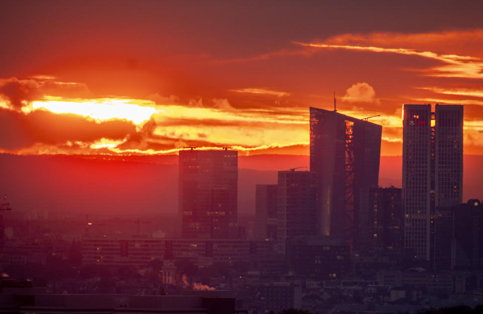 The European Central Bank , 2nd right, is pictured during sunrise in Frankfurt, Germany, Thursday, Oct. 26, 2023. The ECB's governing council will meet in Athens on Thursday. (AP Photo/Michael Probst)