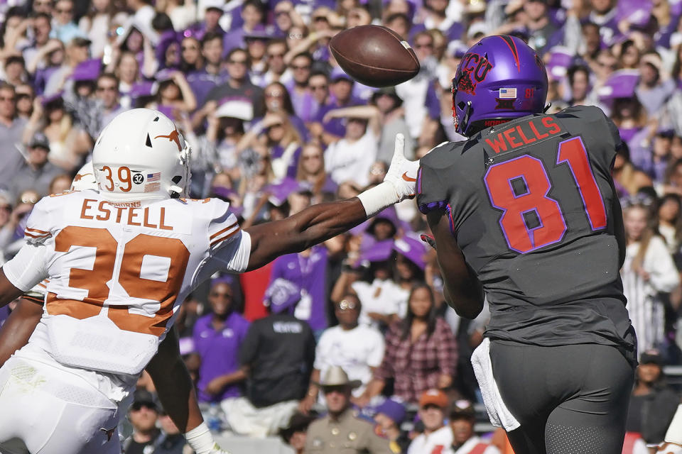 TCU tight end Pro Wells (81) catches a touchdown pass as Texas defensive back Montrell Estell (39) defends in the first half of an NCAA college football game in Fort Worth, Texas, Saturday, Oct. 26, 2019. (AP Photo/Louis DeLuca)