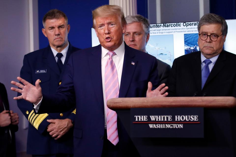 President Donald Trump speaks about the coronavirus on April 1, 2020, as (left to right) Adm. Karl Leo Schultz, commandant of the Coast Guard, national security adviser Robert O'Brien and Attorney General William Barr listen closely. (Alex Brandon/ASSOCIATED PRESS)