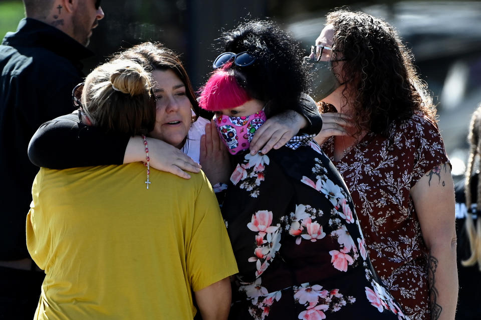 Georgie Gardam, centre, hugs two women during at the funeral of her son, Zane Mellor.