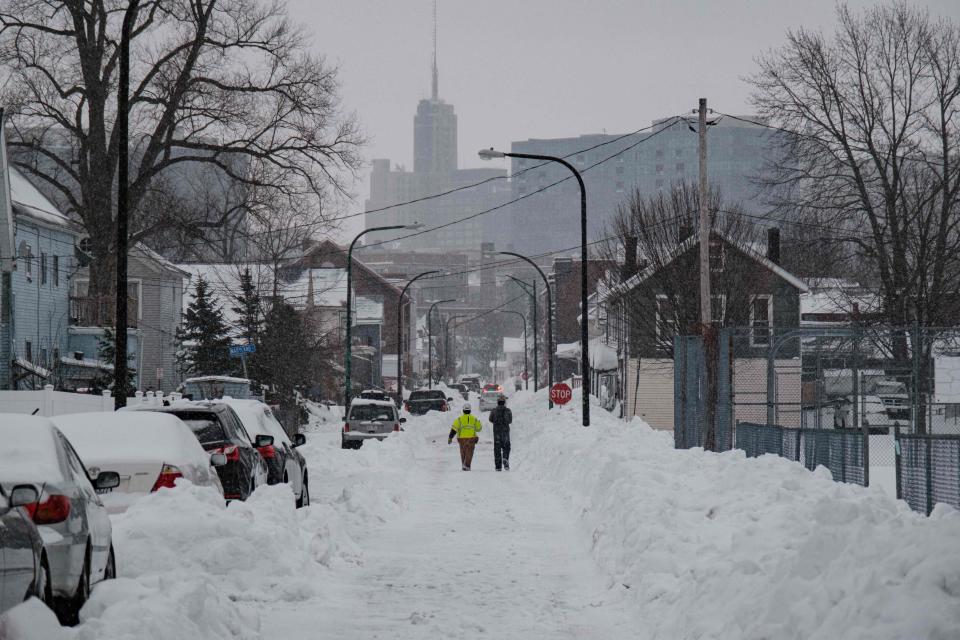 National Grid workers respond to a downed utility pole in Buffalo, New York, on Dec. 27, 2022. The monster storm that killed dozens in the United States over the Christmas weekend continued to inflict misery on New York state and air travelers nationwide Tuesday, as stories emerged of families trapped for days during the "blizzard of the century."