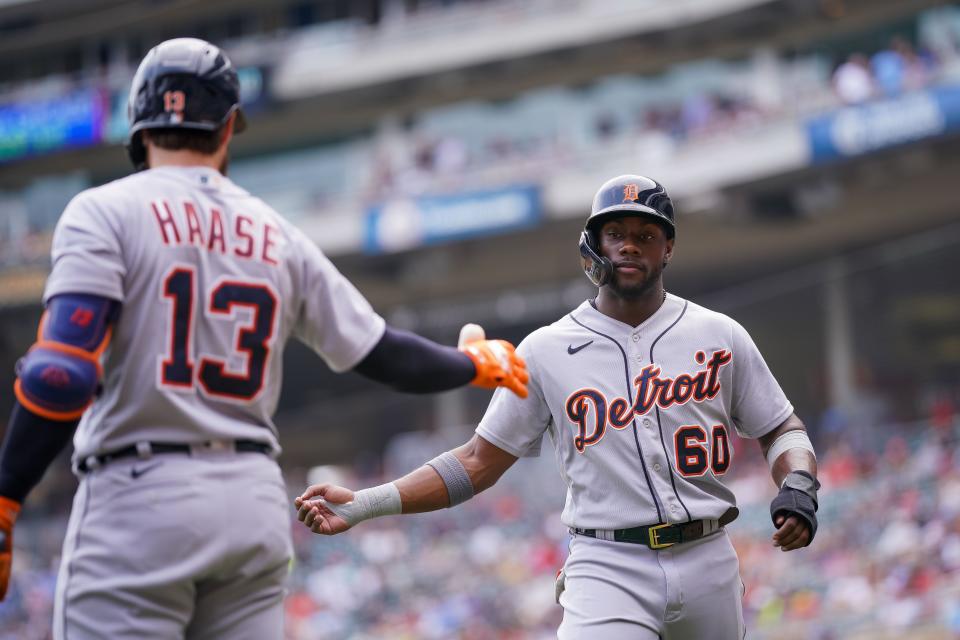 Detroit Tigers outfielder Akil Baddoo (60) celebrates his run with designated hitter Eric Haase (13) against the Minnesota Twins in the fourth inning July 28, 2021at Target Field.