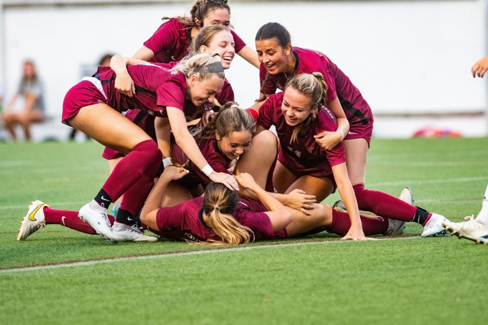 Ashley players celebrate Karina Peat scoring an overtime goal to give the Screaming Eagles a 2-1 lead in the NCHSAA 4A East Regional final on Tuesday, May 30, 2023.