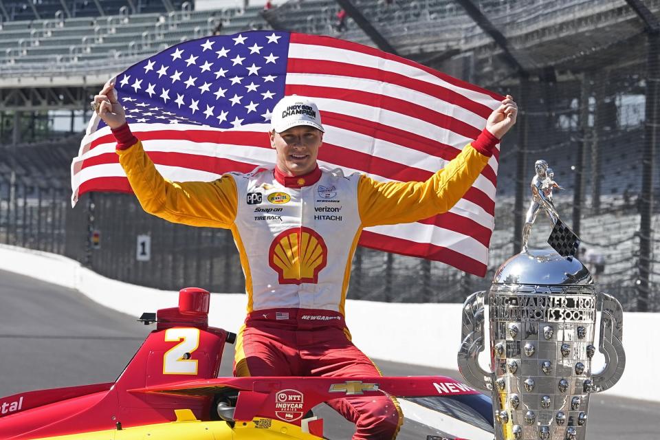 Josef Newgarden poses with the Borg-Warner Trophy during the traditional winners photo session at Indianapolis Motor Speedway, Monday, May 29, 2023, in Indianapolis. Newgarden won the 107th running of the Indianapolis 500 auto race Sunday. (AP Photo/Darron Cummings)