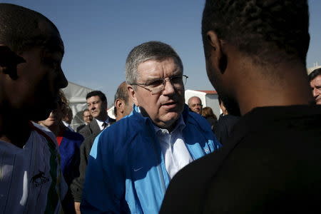 International Olympic Committee President (IOC) Thomas Bach (C) speaks with migrants during a guided media tour at the Eleonas refugee camp in Athens, Greece, January 28, 2016. REUTERS/Alkis Konstantinidis