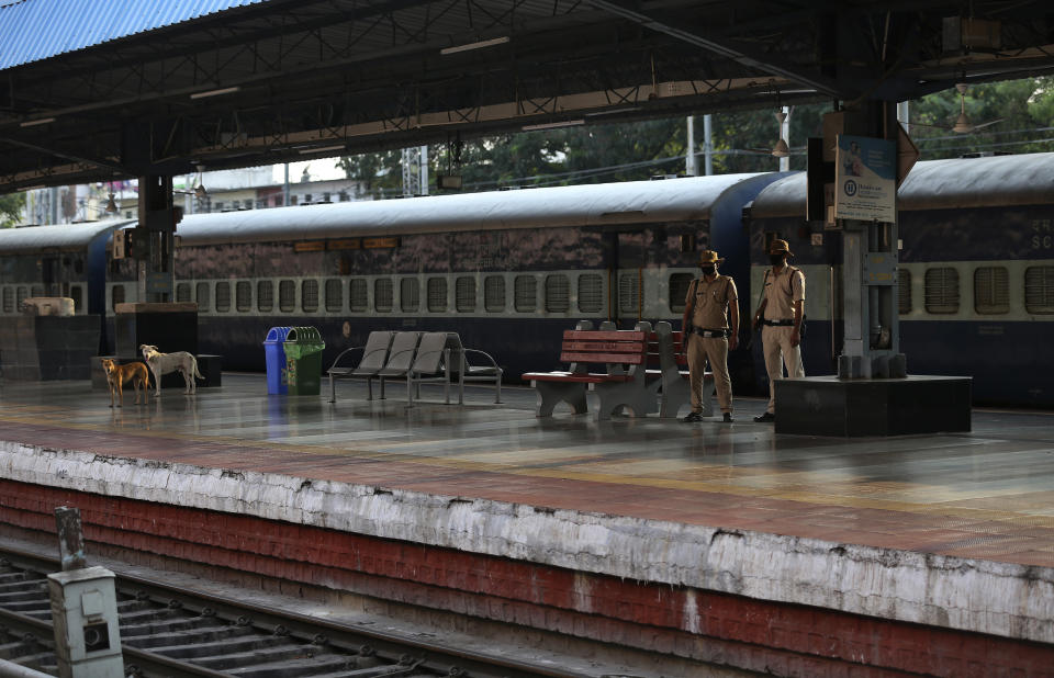 Indian Railway Protection Force personnel wearing face masks patrol at Hyderabad railway station during a lockdown as a precautionary measure against COVID-19 in Hyderabad, India, Monday, March 23, 2020. Authorities have gradually started to shutdown much of the country of 1.3 billion people to contain the outbreak. For most people, the new coronavirus causes only mild or moderate symptoms. For some it can cause more severe illness. (AP Photo/Mahesh Kumar A.)