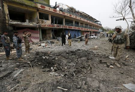 Afghan policemen inspect the site of a blast near the Indian consulate in Jalalabad, Afghanistan March 2, 2016. REUTERS/Parwiz