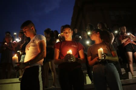 Mourners take part in a vigil at El Paso High School after a mass shooting at a Walmart store in El Paso