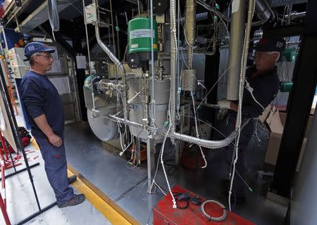 Technicians work on Pemdyn loop which study the behaviour of a large flowrate electro-magnetic pump at the Cadarache CEA (Atomic Energy Authority) site near Saint-Paul-les-Durance, south eastern France, September 26, 2014. REUTERS/Jean-Paul Pelissier