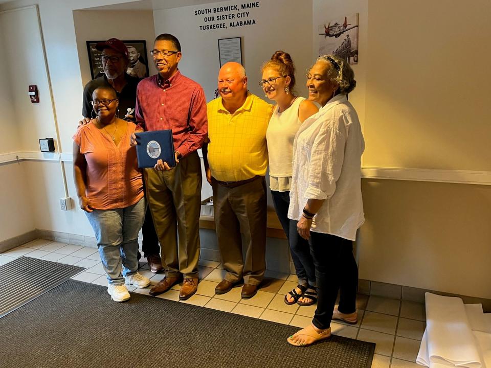 Visitors from Tuskegee, Alabama, stand in front of the new exhibit at South Berwick Town Hall that announces Tuskegee as the town's city and provides a bit of Tuskegee history. From left to right are Sullivan Hanna and Judith Baldwin of Tuskegee; Tuskegee Mayor Tony Haygood; South Berwick Town Manager Tim Pellerin; Tyanne Vasilpoli, South Berwick assistant town clerk, and Rovetta Sullivan of Tuskegee.