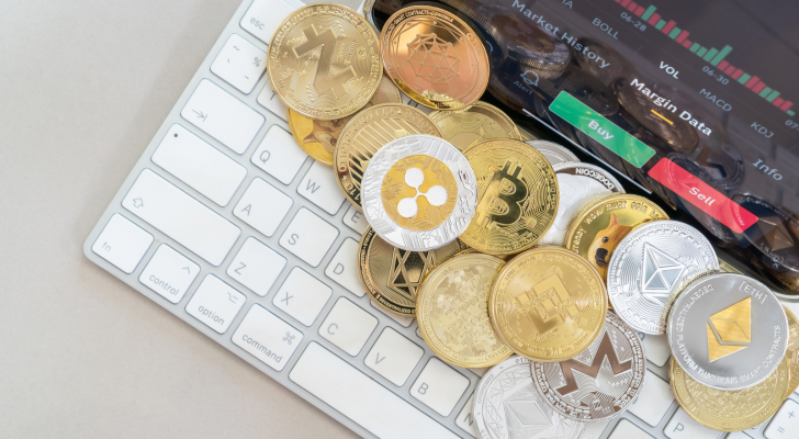 A photo of various crypto coins on a computer keyboard.