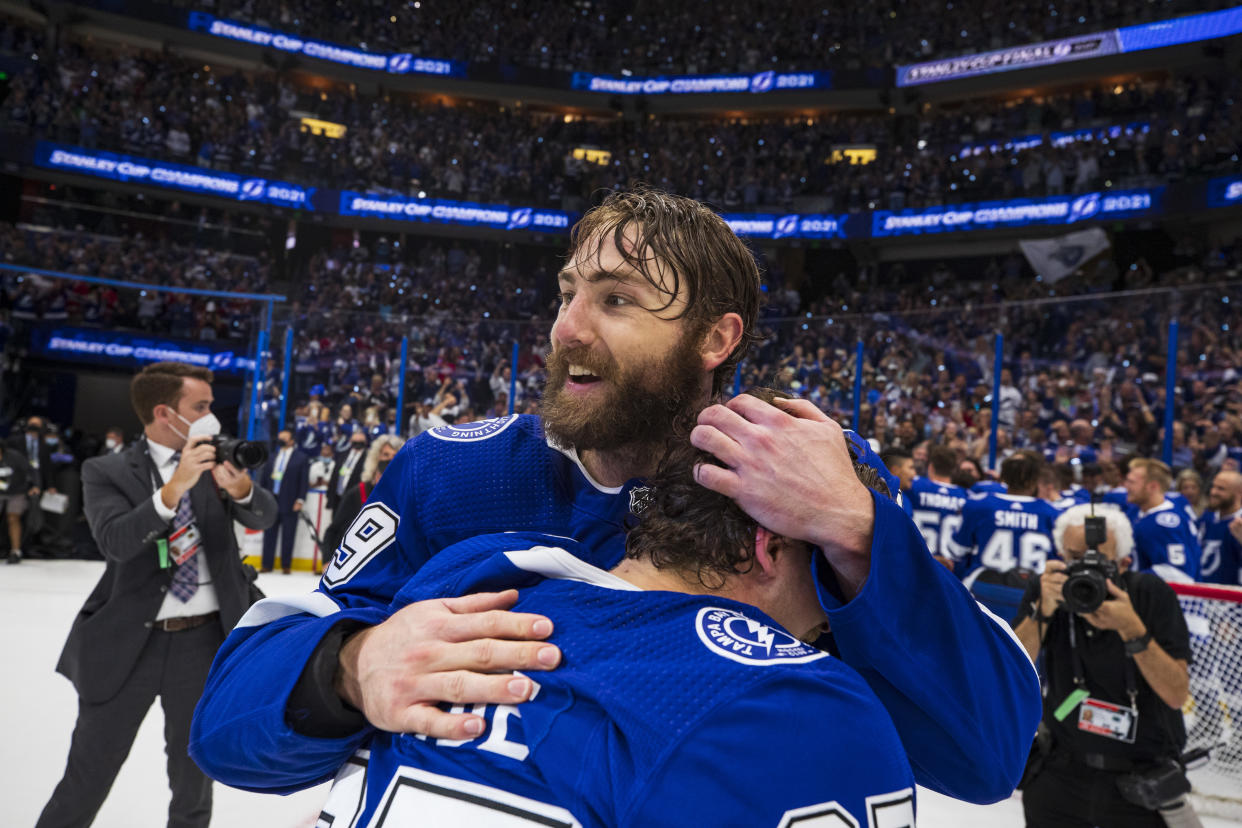 TAMPA, FL - JULY 7: Barclay Goodrow #19 and Yanni Gourde #37 of the Tampa Bay Lightning celebrate winning the Stanley Cup after defeating the Montreal Canadiens in Game Five to win the best of seven game series 4-1 during the Stanley Cup Final of the 2021 Stanley Cup Playoffs at Amalie Arena on July 7, 2021 in Tampa, Florida. (Photo by Scott Audette/NHLI via Getty Images)