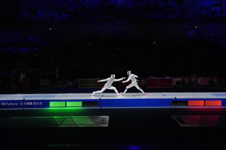 Ka Long Cheung of Hong Kong, left, competes with Haiwei Chen of China in the men's foil individual fencing final at the Hangzhou Dianzi University Gymnasium in the 19th Asian Games in Hangzhou, China, Sunday, Sept. 24, 2023. (AP Photo/Aijaz Rahi)