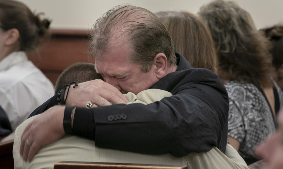 Tim Jones, Sr., embraces his son, Travis Jones during the sentencing phase of Tim Jones Jr.'s trial in Lexington, S.C., Wednesday, June 12, 2019. Timothy Jones, Jr. was found guilty of killing his 5 young children in 2014. (Tracy Glantz/The State via AP, Pool)