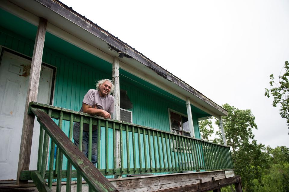 Edison Dardar looks out from his porch where he will ride out Tropical Storm Barry in Isle de Jean Charles, La., on Friday, July 12, 2019. Dardar was born and raised in the community. Isle de Jean Charles is slowly shrinking due to rising sea levels. 