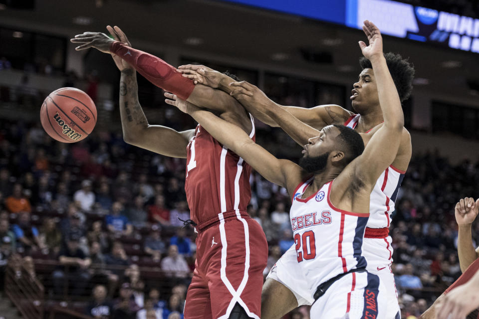 <p>Mississippi guard D.C. Davis (20) and Bruce Stevens, right, battle for a rebound against Oklahoma forward Kristian Doolittle, left, during a first round men’s college basketball game in the NCAA Tournament Friday, March 22, 2019, in Columbia, S.C. (AP Photo/Sean Rayford) </p>