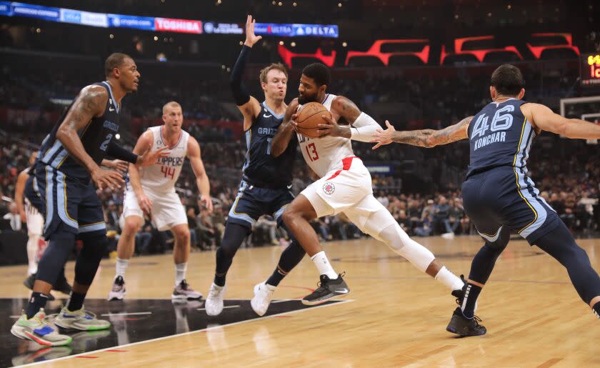 LOS ANGELES, CA - MARCH 05: The Clippers Paul George drives past Memphis Grizzlies' Luke Kennard.