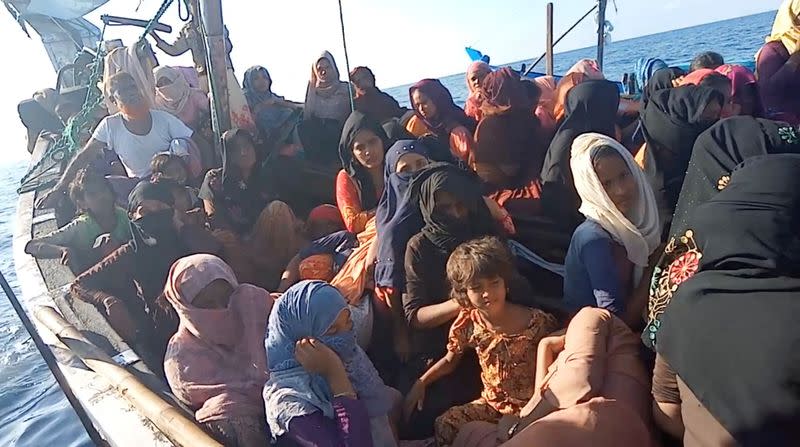 A boat carrying Rohingya refugees, including women and children, is seen stranded in waters off the coast of Bireuen