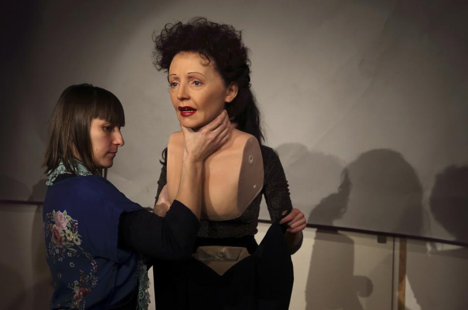 Paris' Grevin Wax Museum staff dismantle the wax statue of late French singer Edith Piaf in their workshop in Paris