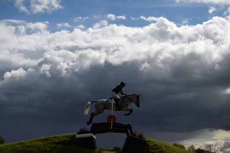 A horse and its rider jump over a hurdle in the Tattersalls International Horse trials in Ratoath, Ireland, June 3, 2017. REUTERS/Clodagh Kilcoyne