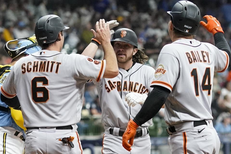 San Francisco Giants' Brett Wisely is congratulated by Casey Schmitt and Patrick Bailey (14) after hitting a three-run home run during the third inning of the team's baseball game against the Milwaukee Brewers on Friday, May 26, 2023, in Milwaukee. (AP Photo/Morry Gash)