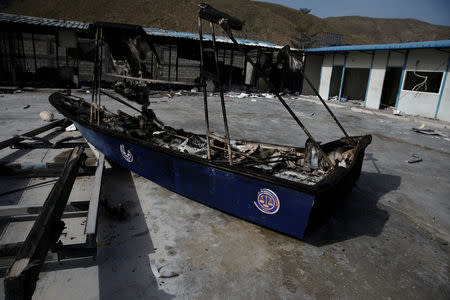 A burnt boat is seen inside the customs facilities in Malpasse, Haiti, July 8, 2018. REUTERS/Andres Martinez Casares