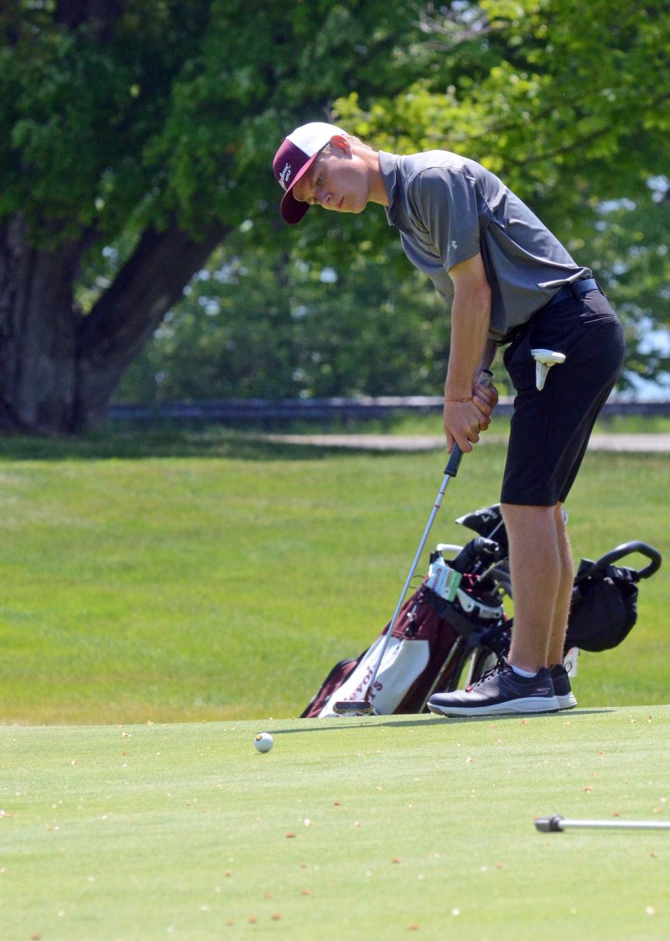 Charlevoix senior Sam Pletcher keeps a close eye on a putt during Tuesday's round.