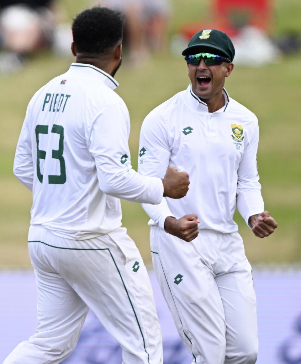 South Africa bowler Dane Piedt, left, celebrates with teammate Zubayr Hamza after the wicket of New Zealand's Tom Latham on the second day of their cricket test in Hamilton, New Zealand. Wednesday, Feb. 14, 2024. (Andrew Cornaga/Photosport via AP)