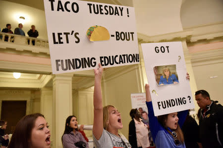 Teachers rally inside the state Capitol on the second day of a teacher walkout to demand higher pay and more funding for education in Oklahoma City, Oklahoma, U.S., April 3, 2018. REUTERS/Nick Oxford