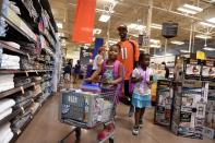 <p>Young Alize Keys, middle left, and Ke’yondriah Hugely, right, both 6, lead Denver Broncos wide receiver Jordan Norwood, #11, through the aisles as they shop for school supplies at King Soopers Marketplace on July 25, 2016 in Parker, Colorado. </p>