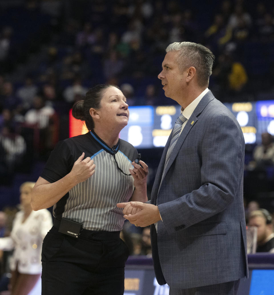 McNeese head coach Lynn Kennedy speaks with a game official as he coaches against LSU, during an NCAA basketball game, Tuesday, Dec. 12, 2023, in Baton Rouge, La. (Hilary Scheinuk/The Advocate via AP)