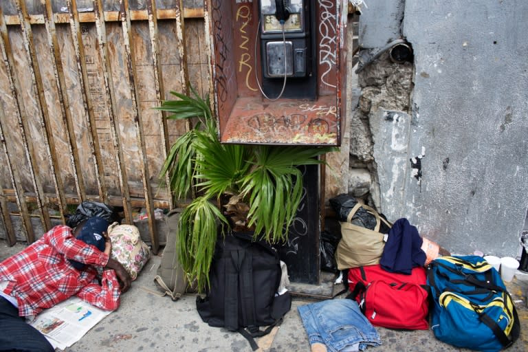 A migrant seeking asylum in the United States, sleeps on the sidewalk on the Mexican side of the San Isidro Port of Entry, in Tijuana, northwestern Mexico