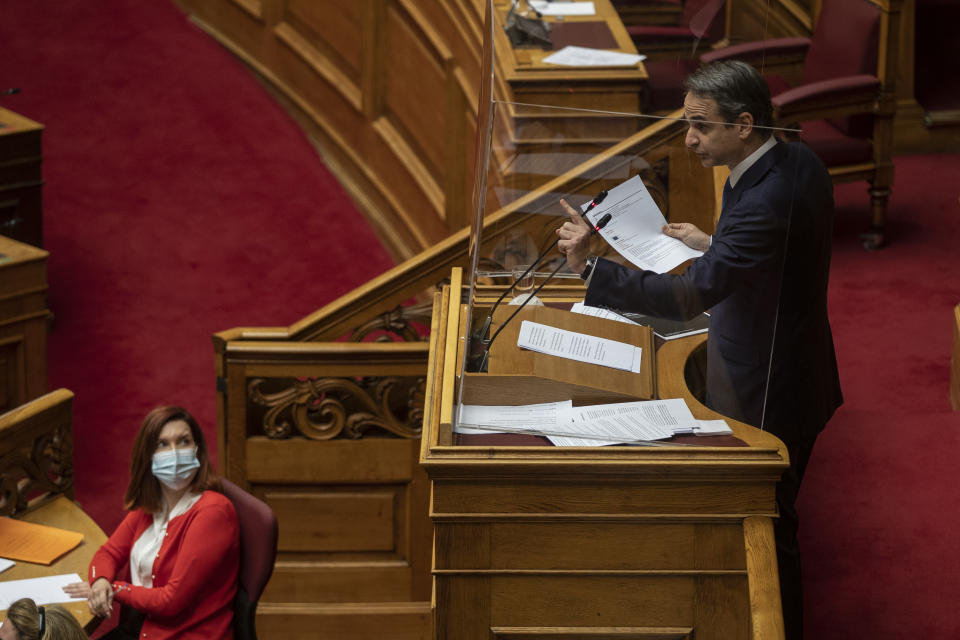 Greek Prime Minister Kyriakos Mitsotakis speaks during a parliamentary session in Athens, Thursday, Feb. 25, 2021. Mitsotakis has promised to outline proposed legal changes in parliament on Thursday to make it easier for victims of sexual assault to report the crimes. (AP Photo/Petros Giannakouris)