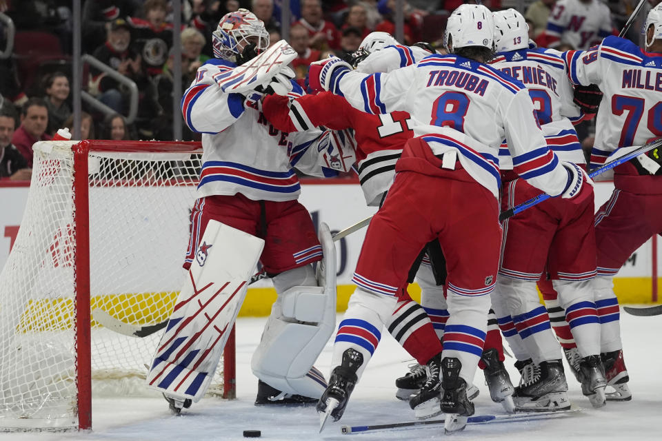 New York Rangers goaltender Igor Shesterkin, left, and Chicago Blackhawks left wing Nick Foligno scuffle during the first period of an NHL hockey game Friday, Feb. 9, 2024, in Chicago. (AP Photo/Erin Hooley)