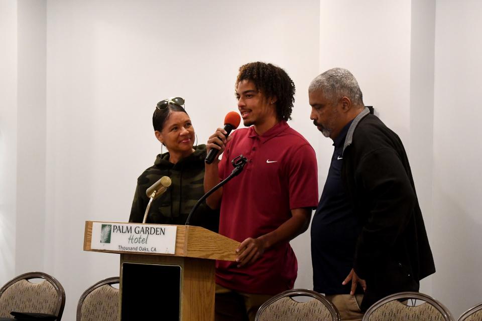 Simi Valley High's Sean Brown announces his intent to attend Michigan State while flanked by his parents during the Ventura County Coaches Signing Luncheon at the Palm Garden Hotel in Newbury Park on Wednesday, Feb. 1, 2023.