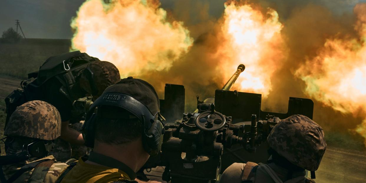 Ukrainian soldiers fire a cannon near Bakhmut