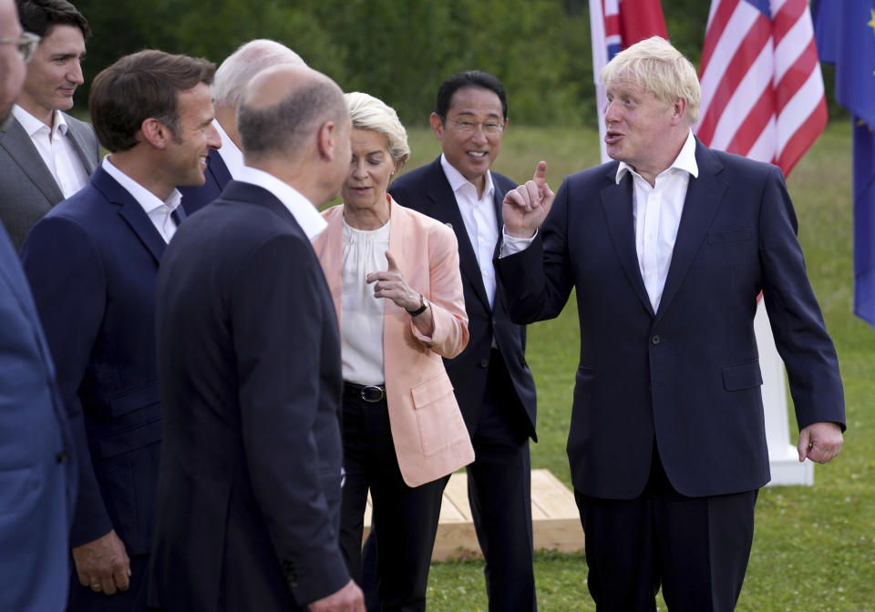 British Prime Minister Boris Johnson, right, speaks with, from left, European Council President Charles Michel, Canada's Prime Minister Justin Trudeau, French President Emmanuel Macron, U.S. President Joe Biden, German Chancellor Olaf Scholz, European Commission President Ursula von der Leyen and Japan's Prime Minister Fumio Kishida and European Commission President Ursula von der Leyen after the official G7 group photo at Castle Elmau in Kruen, near Garmisch-Partenkirchen, Germany, on Sunday, June 26, 2022. The Group of Seven leading economic powers are meeting in Germany for their annual gathering Sunday through Tuesday. (AP Photo/Matthias Schrader)