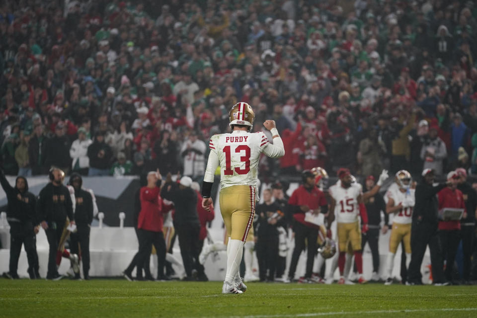 San Francisco 49ers quarterback Brock Purdy reacts after running back Christian McCaffrey, not visible, scored on a touchdown run against the Philadelphia Eagles during the first half of an NFL football game, Sunday, Dec. 3, 2023, in Philadelphia. (AP Photo/Matt Slocum)