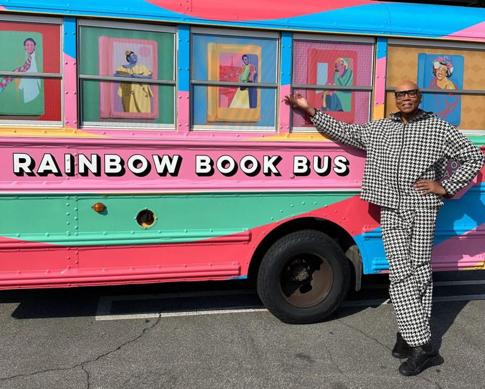 Drag sensation RuPaul stands in front of the Rainbow Book Bus, which is traveling across the South distributing banned books to needy readers.