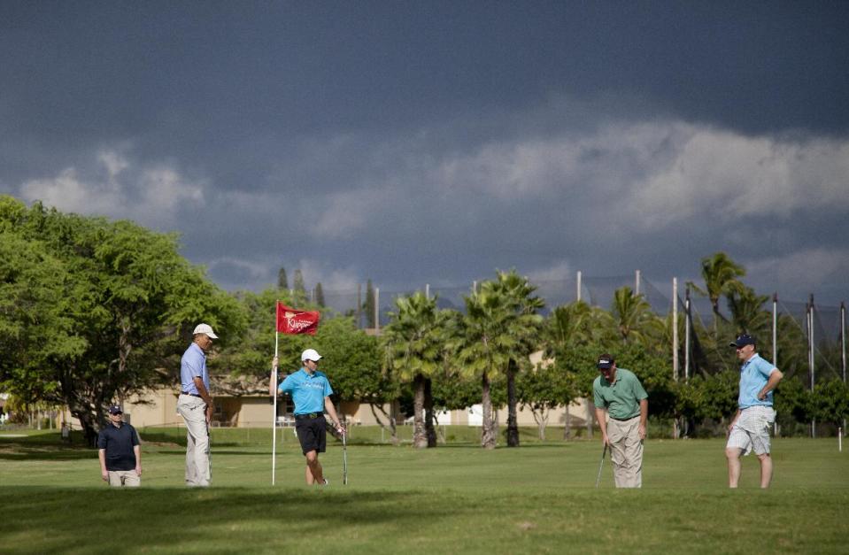 President Barack Obama, left, New Zealand Prime Minister John Key, right, and son Max Key second from left, and Marvin Nicholson, golf on the second green at Kaneohe Klipper Golf Course on Marine Corps Base Hawaii in Kaneohe Bay, Hawaii, Thursday, Jan. 2, 2014. The first family is in Hawaii for their annual holiday vacation. (AP Photo/Carolyn Kaster)