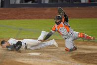 Baltimore Orioles catcher Pedro Severino holds up his glove with the ball in it after tagging out New York Yankees' Gio Urshela during the 11th inning of a baseball game Wednesday, April 7, 2021, at Yankee Stadium in New York. (AP Photo/Kathy Willens)