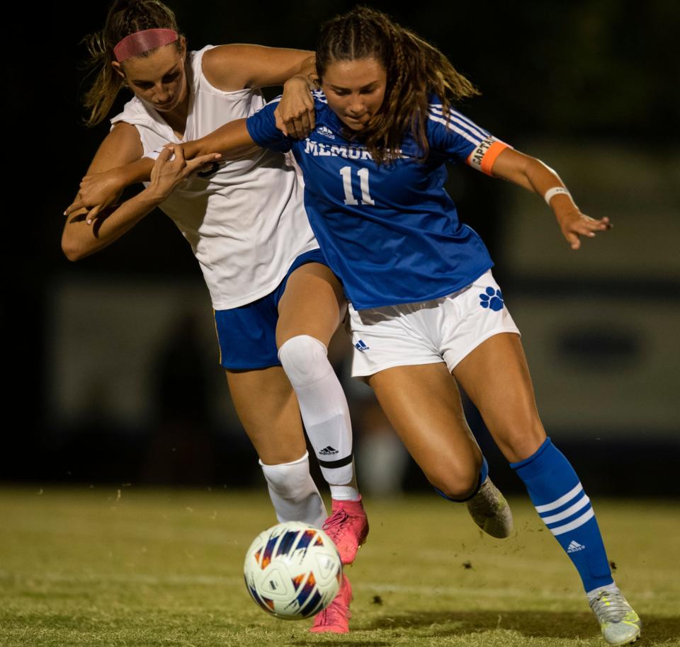 Memorial’s Kennedy Neighbors (11) is defended by Castle’s Adrienne Woodland (6) as the Memorial Tigers play the Castle Knights at Memorial High School in Evansville, Ind., Tuesday evening, Sept. 13, 2022.